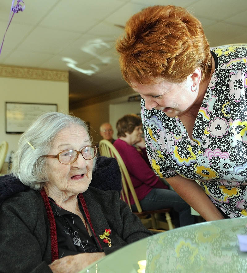 105 YEARS YOUNG: MaryAnne Berube, left, chats with staffer Darcey Botbyl during a party for her 105th birthday on Thursday at the Capt. Lewis Residence in Farmingdale. Berube was born in Waterville, grew up in Winslow, where she was the 11th of 15 children. She raised three children in Auburn and moved to Farmingdale about two years ago.