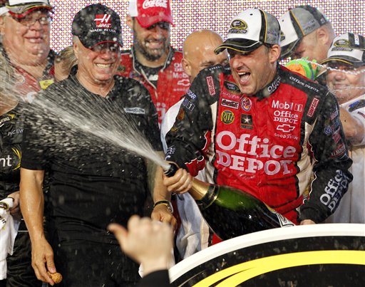 Tony Stewart, right, and team co-owner Carl Haas, left, celebrate after Stewart won the Ford 400 on Sunday and clinched the series championship.