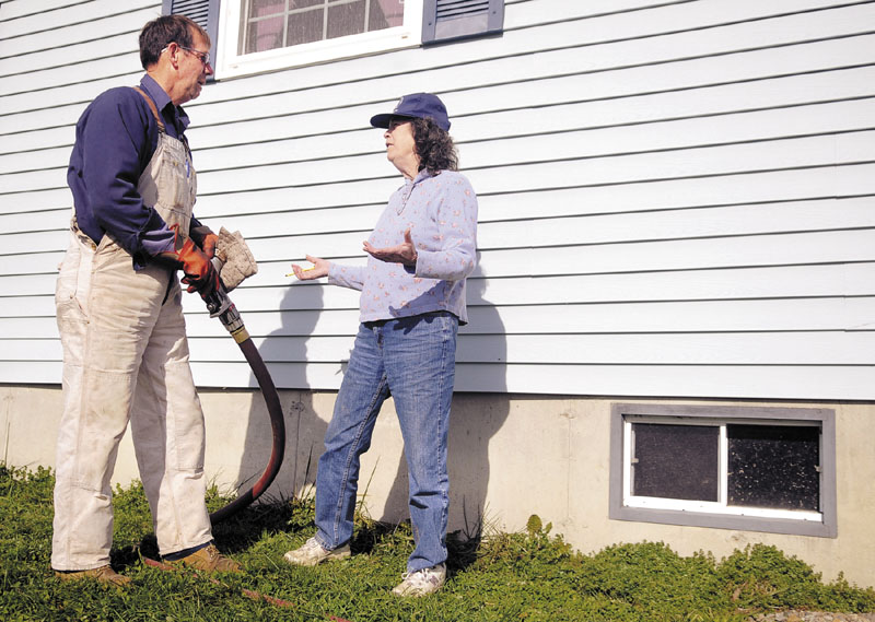 Danny Chapman speaks with Elizabeth Street as he fills an oil tank in Chelsea belonging to her daughter with heating oil. The U.S. average for home heating oil on Nov. 21 was $3.93 per gallon; in Maine it was $3.75, according to U.S. energy numbers.
