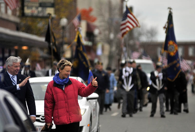 PARADE: Rep. Mike Michaud, left, and Waterville Mayor-Elect Karen Heck wave to people on Main Street during the Veterans Day parade Friday in Waterville.