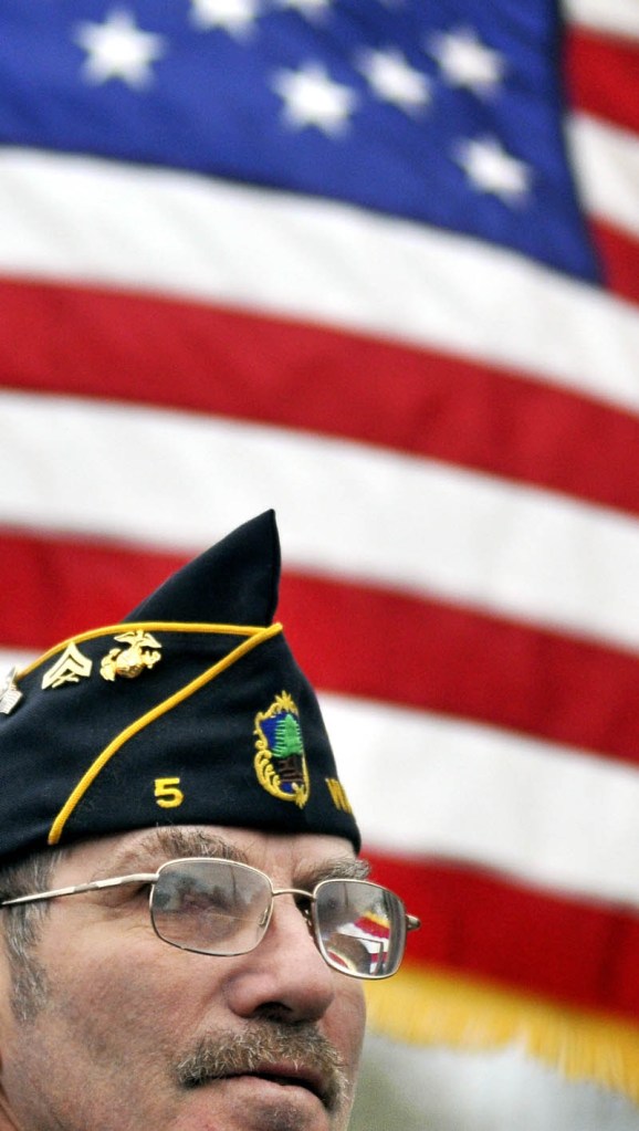 Staff photo by Michael G. Seamans Clyson Hardy listens to speakers at the American Legion parking lot off of Front Street in Waterville after the Veteran's Day parade.