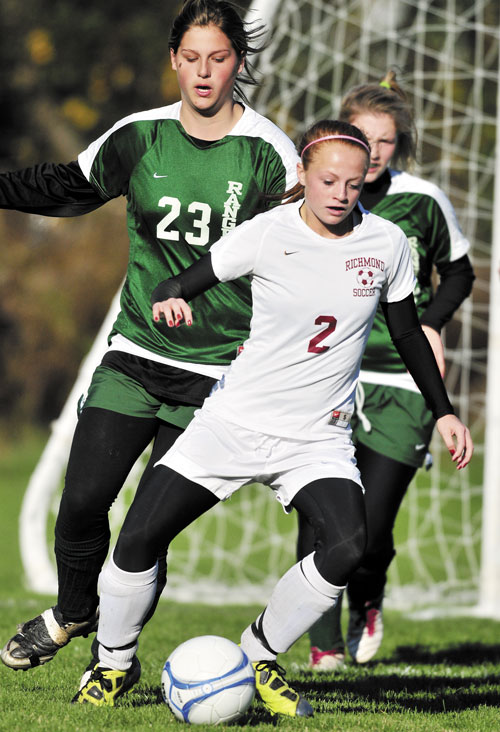 READY TO GO: Richmond High School’s Noell Acord maneuvers around Rangeley Lakes Regional High School defenders during a Western Class D semifinal game Saturday in Richmond. The top-ranked Bobcats won 6-0 and will host No. 2 Greenville in the regional final at 1 p.m. today.