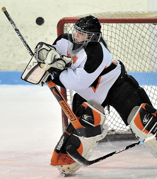 NOT THIS TIME: Winslow High School goalie Jessica Cain makes a save against Scarborough High School during the first period Friday at Sukee Arena in Winslow.