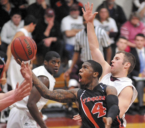 COMING THROUGH: Thomas College guard Stanley Green Jr. (4) drives past University of Maine at Farmington’s Andrew Dean, right, last season at Dearborn Gymnasium at the University of Maine at Farmington. Green returns for the Terriers this year after averaging nearly 8 points per game last season.