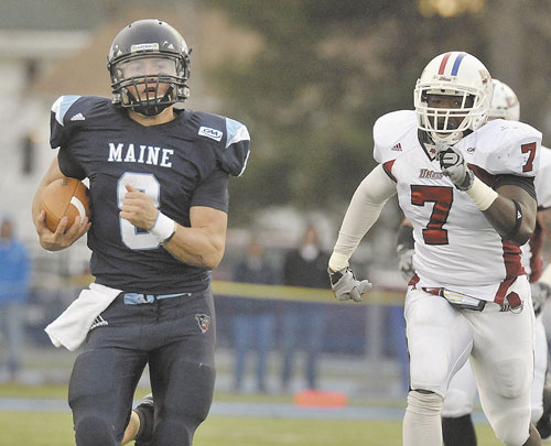 HEADING FOR THE END ZONE: Maine quarterback Warren Smith (8) takes the ball downfiield for some yardage with Massachusetts’ D.J. Adeoba (7) in pursuit earlier this month in Orono. Smith and the Black Bears will travel to Boone, N.C., to play Appalachian State in front of possibly more than 20,000 fans.