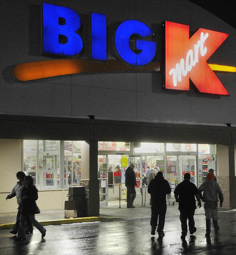 Shoppers come and go from the Kmart at 6:08 a.m. Friday in Augusta. Shopping centers were crowded overnight as retailers were offering big discounts. Some stores opened as early as 12:01 a.m.
