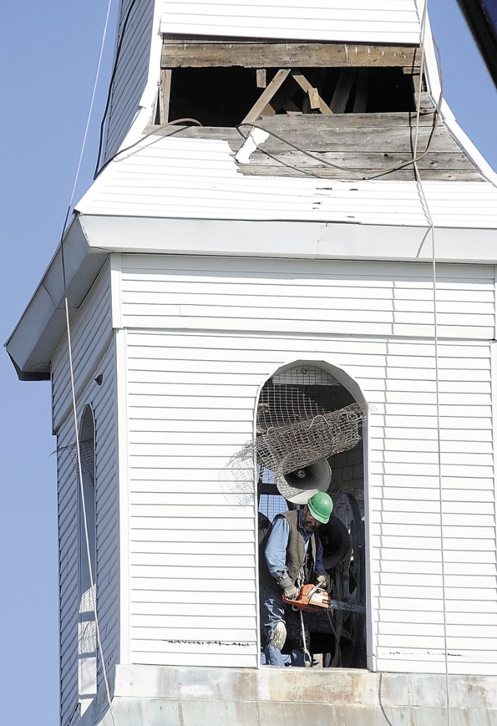STEEPLE PEOPLE: Steeplewright Robert Hanscom is seen inside the tower with the chainsaw he used to cut posts connecting the steeple to the Cox Memorial Methodist Church in Hallowell on Friday morning.