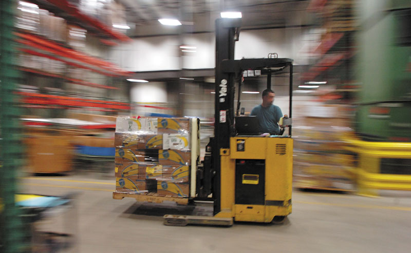 Philip Perry runs a forklift recently at the Good Shepherd Food Bank in Auburn.