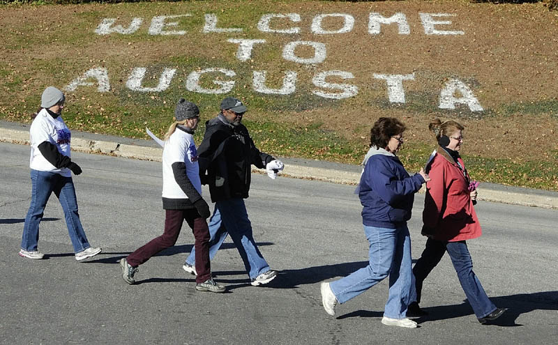 FREE TO BREATHE: People walk down Water Street during third annual Free to Breathe Walk Saturday in Augusta.They were on a 1.6-mile loop that began and ended at Augusta City Center. About 250 people walked in the event and raised $30,000 to benefit the National Lung Cancer Partnership’s research, education and awareness programs.