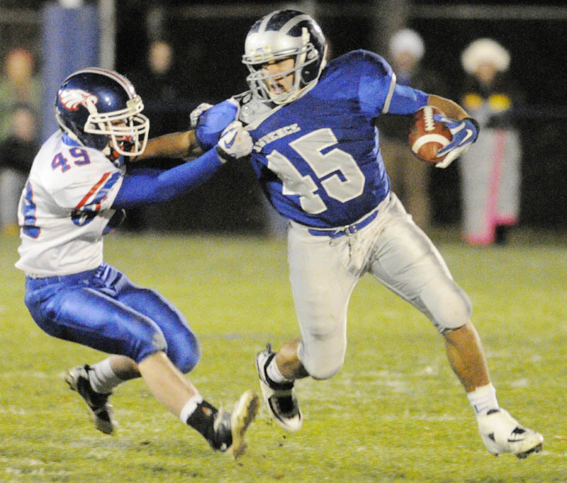 Messalonskee linebacker Kyle Gleason, left, drags down Lawrence's Bryant Wade during a game on Keyes Field in Peter Cooper Stadium Friday night in Fairfield.