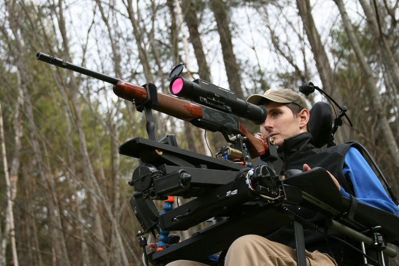 Jeff Molloy, a quadriplegic, demonstrates his adaptive shooting device Sunday at his home in Palermo. Molloy and his friend, machinist Ray Kimball, designed and built the device, called the Equalizer Shooting System. On Nov. 12 in Albion, Molloy used the system to bag a 118-pound four-point buck.