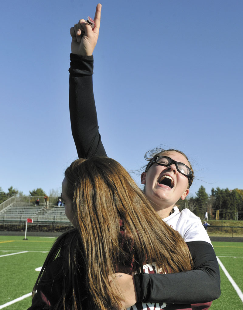 Richmond's Payton Johnson raises her hand high while celebrating her team's championship win.