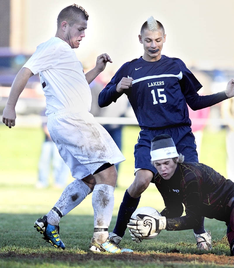 Greenville goalkeeper Cory Henderson makes a save as Richmond's Randy Moody, left, and Greenville's Matt DiAngelo converge in front of the net during the Western Maine Class D championship game Wednesday afternoon in Richmond.