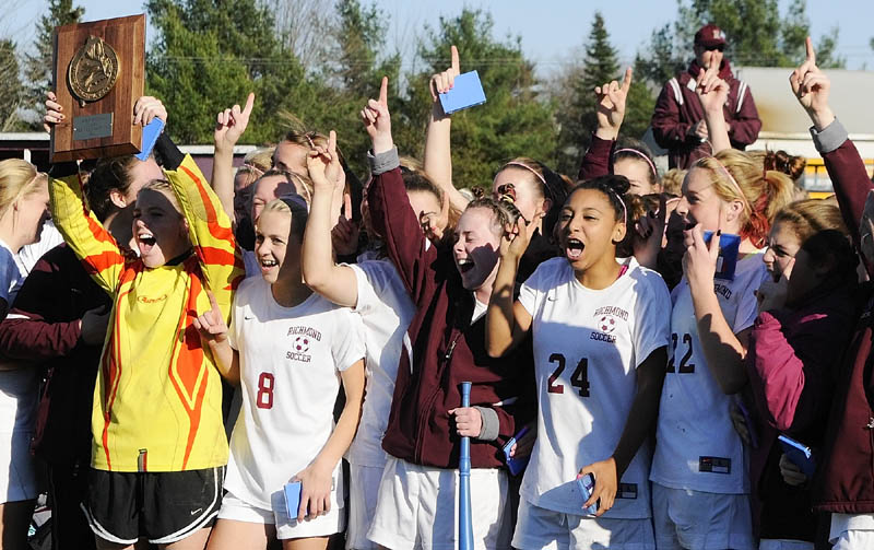 Staff photo by Joe Phelan The Richmond Bobcats hold up the plaque emblematic of winning the Class D Western Maine regional championship game Wednesday afternoon in Richmond.