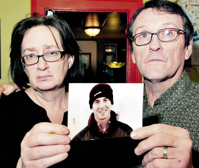 FAMILY: Lorna and Michael Smilek hold a 2006 photo of Michael’s son Justin Crowley-Smilek on Sunday. Crowley-Smilek was shot and killed on Saturday after he confronted Farmington police. Michael Smilek said his son was a U.S. Army Ranger in Afghanistan and came home with severe combat stress.