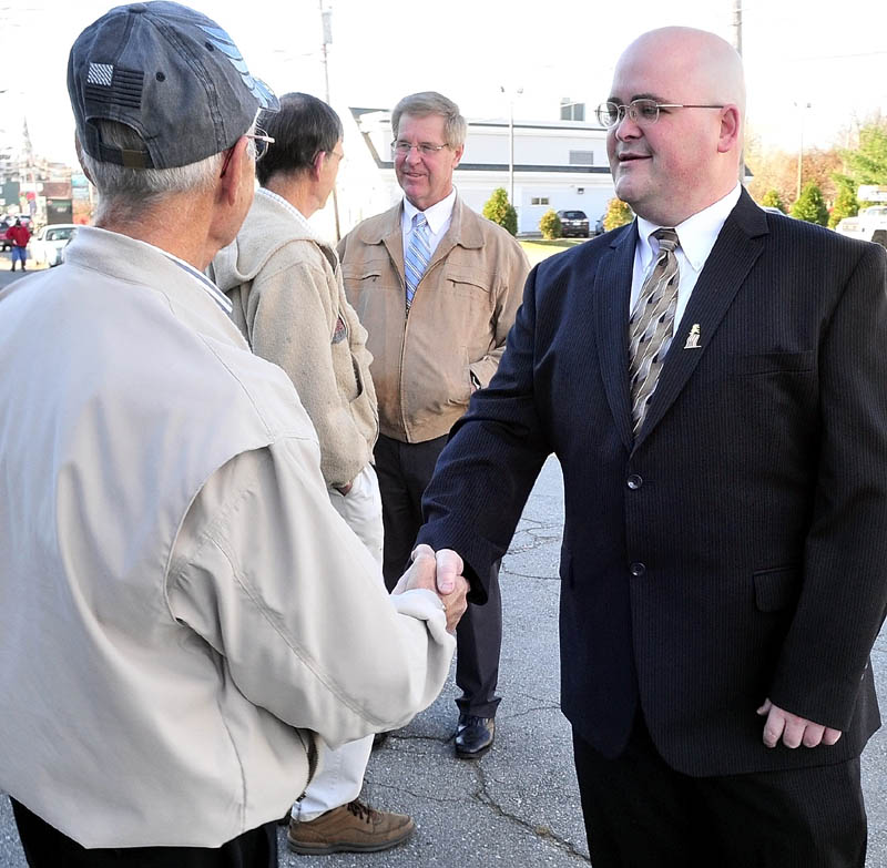 CANDIDATES: Waterville mayoral candidates Dana Sennett, center, and Andrew Roy, right, speak with supporters Tuesday outside the polls at the American Legion in Waterville.