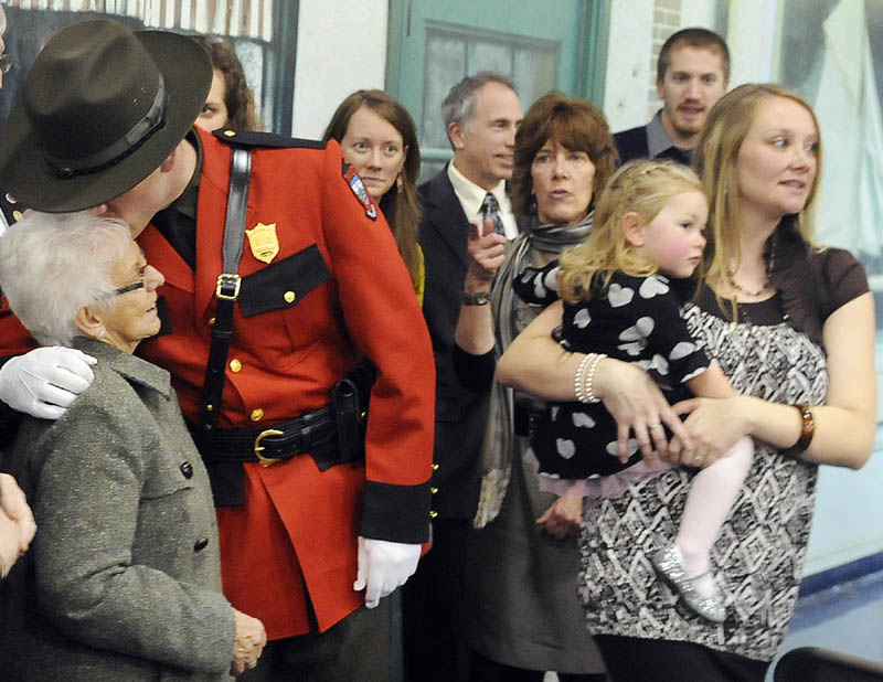 GRADUATION KISSES: Game Warden Troy Thibodeau kisses his grandmother, Bernadette Winters, after a graduation ceremony Friday for 54 students who attended the Maine Criminal Justice Academy in Vassalboro. Officers from state agencies, county sheriff departments, municipalities and students enrolled at Thomas College completed the four-month course in basic law enforcement. Thibodeau, 30, of Augusta, is the class president at the academy and will serve as a district game warden with Inland Fisheries and Wildlife.