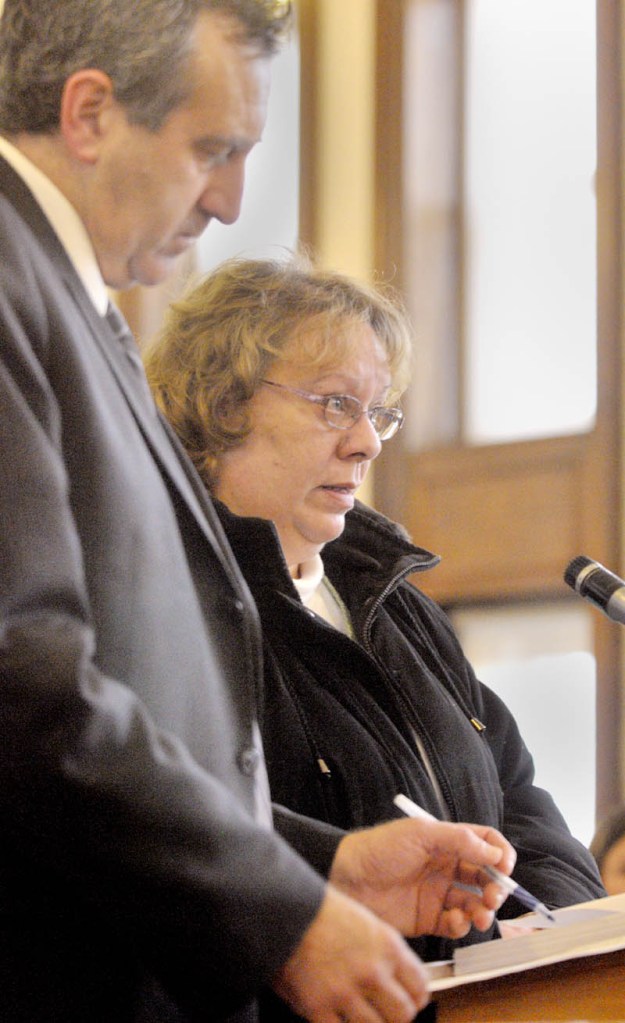 Bettysue Higgins stands with her attorney Ronald Bourget in Kennebec County Superior Court where she pleads guilty to embezzlement Wednesday morning.