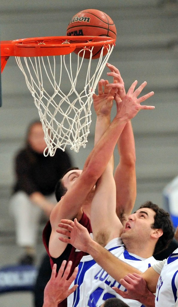 BATTLE FOR THE BOARD: Colby College’s Eric Beaulieu, right, battles for a rebound with Bates’ John Squires in the first half of the Bobcats’ 63-36 win Saturday at Wadsworth Gymnasium in Waterville.