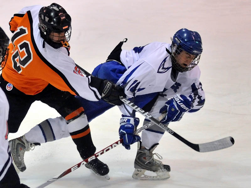 SHOT OFF: Gardiner Area High School’s Jeff McAuslin, left, takes a shot as Lawrence High School’s Tyler Stevens tries to defend in the first period Wednesday night at Sukee Arena in Winslow.