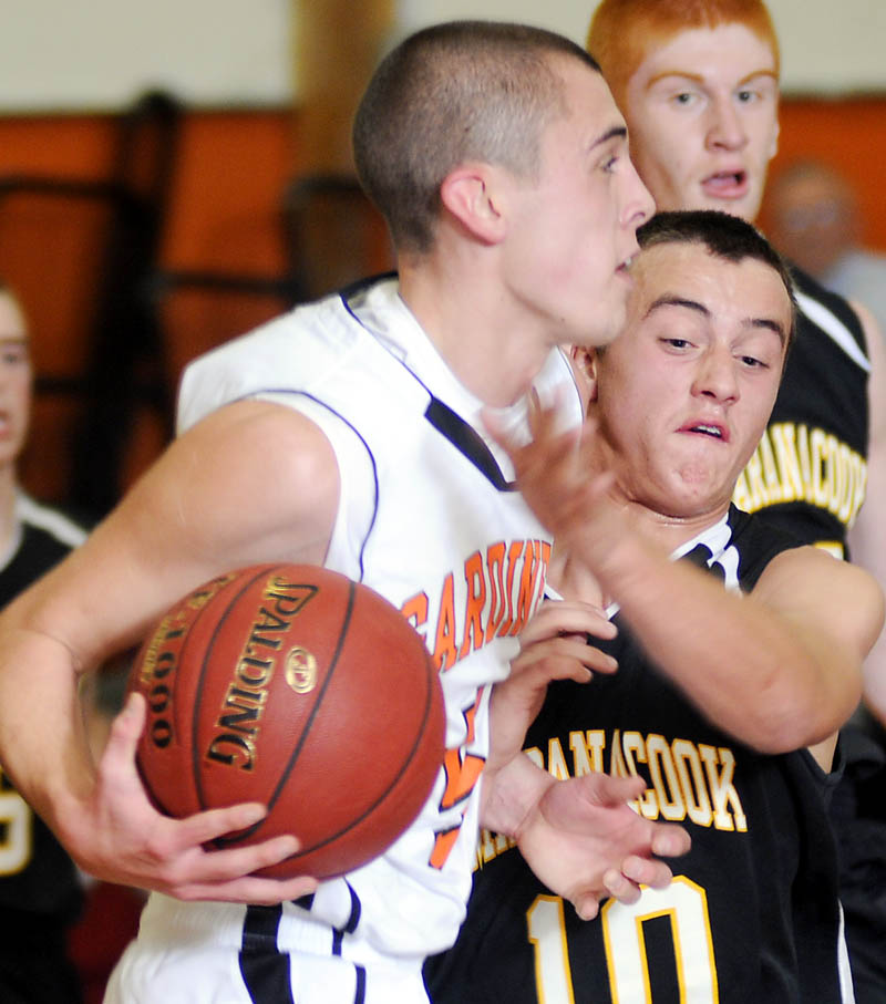 Staff photo by Andy Molloy OVER THE TOP: Maranacook Community High School's Jesse Evans, right, blocks Tuesday Gardiner Area High School's Jake Palmer during a basketball match up in Gardiner.