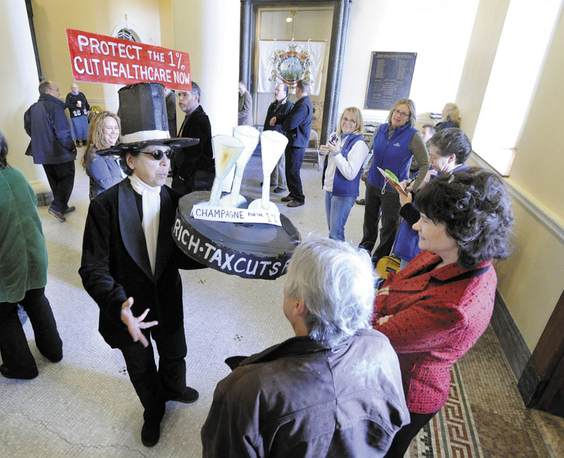 Natasha Mayers from Whitefield makes her statement before a rally Wednesday in the Hall of Flags at the State House in Augusta as legislators began public hearings on the proposed cuts to MaineCare.