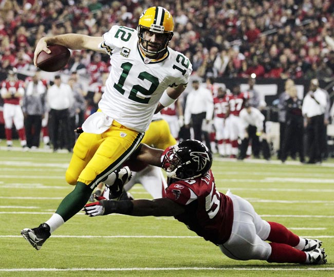 Green Bay Packers quarterback Aaron Rodgers scrambles past Atlanta Falcons linebacker Curtis Lofton during a divisional playoff game on Jan. 15, 2011.