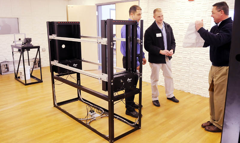 Mark Bajako, right, discusses a pattern of bullets striking a product composed of materials made at Tex Tech Industries with Brian Smith, center, and Scott Janco at the Monmouth company's new ballistic range. Bajako, of Point Blank Body Armour, and Smith, of the Bangor Police Department, spoke with Janco in the new ballistic range that he manages at Tex Tech.
