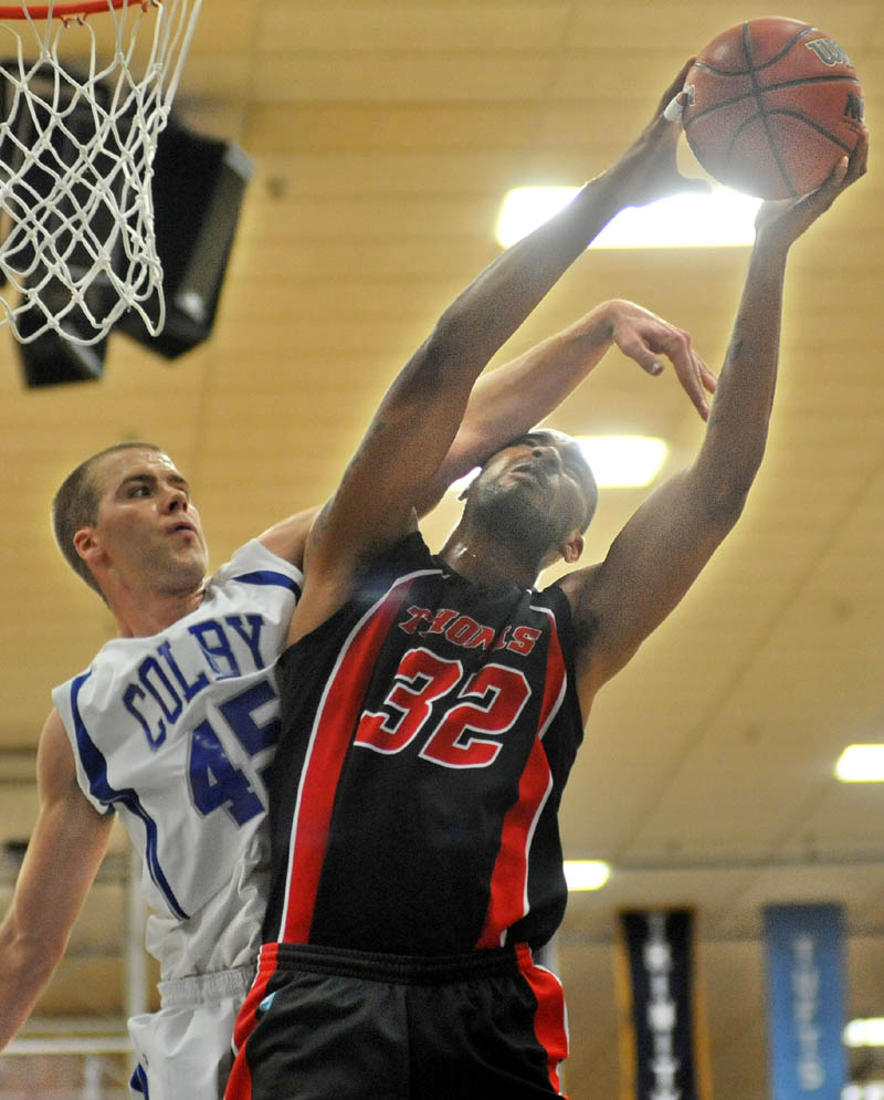 Thomas College's Martin Cleveland, right, draws the foul from Colby College's Kyle Donovan during the first half Tuesday at Colby's Wadsworth Gymnasium in Waterville.