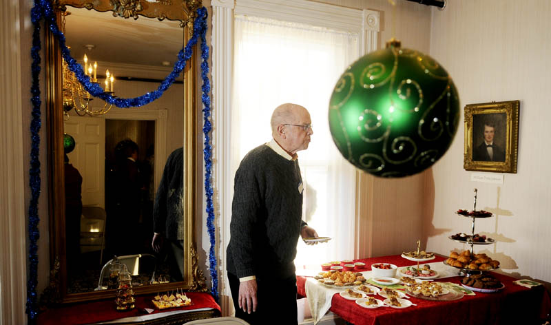 Bruce Kirkham samples a sweet Sunday during the Victorian tea at the Kennebec Historical Society in Augusta.