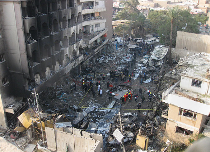 Iraqi security forces gather the scene of a car bomb attack in Baghdad Thursday. A wave of bombings ripped across Baghdad in the worst violence Iraq has seen for months. The bloodbath comes just days after American forces left the country.