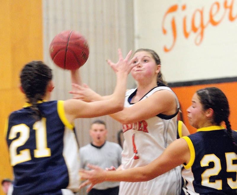 Gardiner's Kylee Granholm passes under pressure from Medomak Valley's Mallory Conary, left, and Amanda Belloauet Hendrickson during a Friday night game in the John A. Bragoli Memorial Gym at Gardiner Area High School.