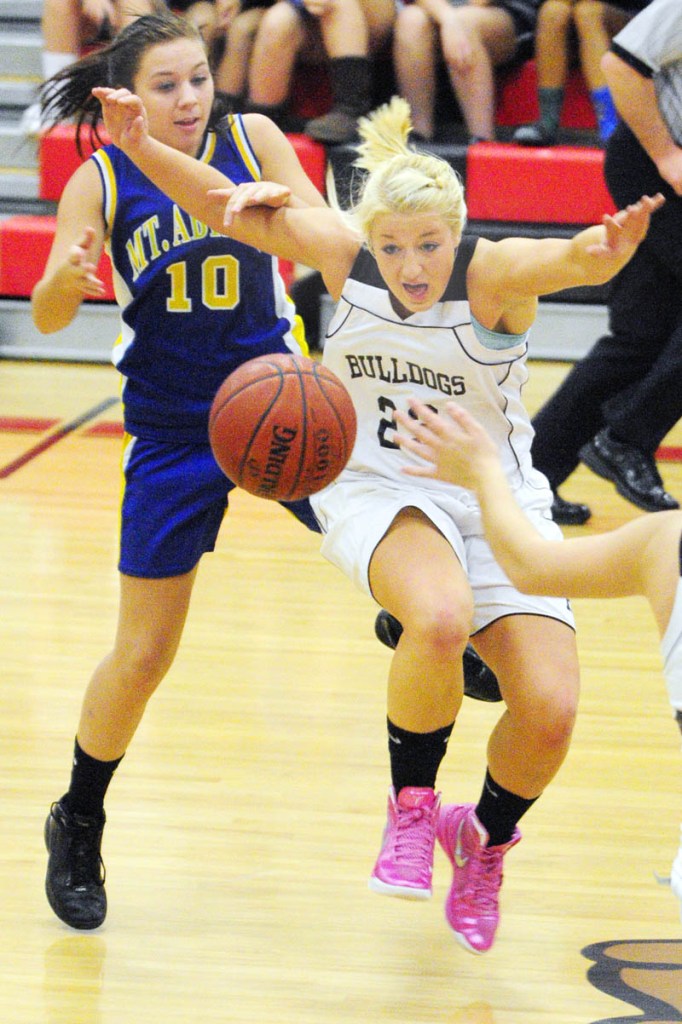 BATTLE FOR POSSESSION: Mt. Abram’s Samantha Werzansk, left, and Hall-Dale’s Carylanne Wolfington battle for a loose ball during a game Thursday night at Hall-Dale High School’s Penny Memorial Gymnasium in Farmingdale.