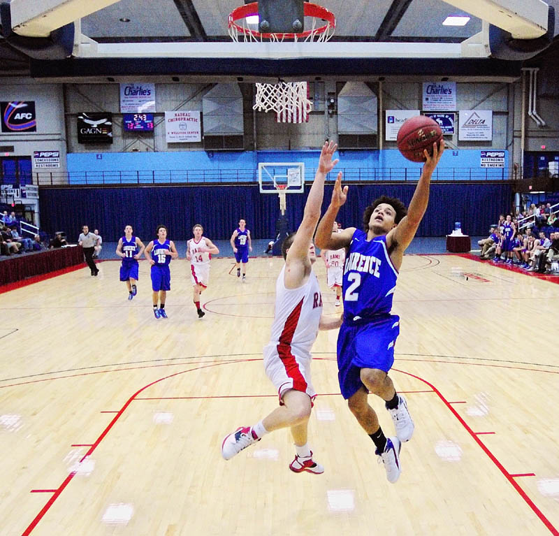 ON THE BREAK: Cony’s Zach Lachance, left, tries to stop a fast break by Lawrence’s Shaun Carroll during The Capital City Hoop Classic on Wednesday at the Augusta Civic Center.