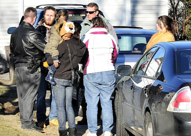 LOOKING FOR CLUES: Maine State Police Detective Christopher Tupper, left, talks to Justin DiPietro on Dec. 18 at his home on Violette Avenue in Waterville. His daughter, 20-month-old Ayla Reynolds, has been missing since Dec. 17.