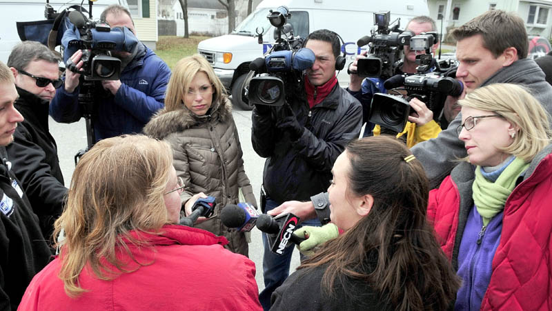 On Monday local, state, and regional media interview Amy Taylor, left front, and Mirisha Lawler near the home on Violette Ave. in Waterville where Ayla Reynolds was reported missing since Friday. The women said they were on their lunch break and wanted to assist in the search effort for the 20-month-old girl.