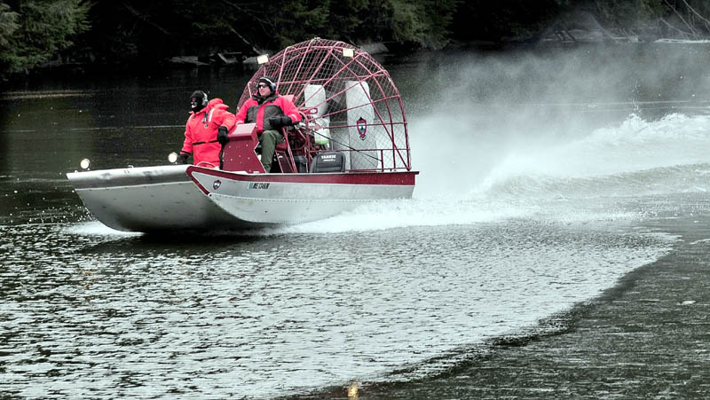 WATER SEARCH: Searchers in a Maine Warden Service airboat motor on the ice-covered Messalonskee Stream in Waterville on Monday in search of missing 20-month-old Ayla Reynolds. The search area was concentrated below the dam near Western Avenue, a short distance from Reynold's home on Violette Avenue.