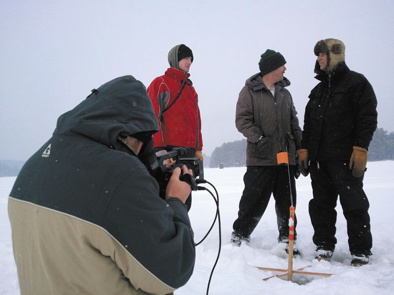 CAPTURING THE MOMENT: Dan Sites, one of the two filmmakers of “Hardwater,” films Jeff Howatt, Roger Bolduc and Howatt’s son, Ethan, as they wait for a fish to finish chomping on the bait before setting the hook in his mouth on Great Pond in Rome.