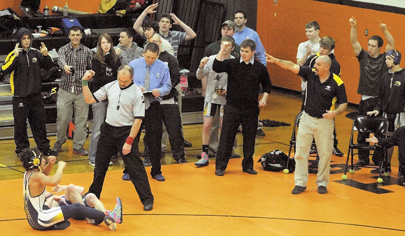 THE WINNER: Mt. Blue’s Khalil Newbill, bottom, left, and his Cougar teammates celebrate his overtime win over Morse’s Dylan Harrington in the 120-pound finals at the Tiger Invitational on Saturday in the John A. Bragoli Memorial Gym at Gardiner Area High School.