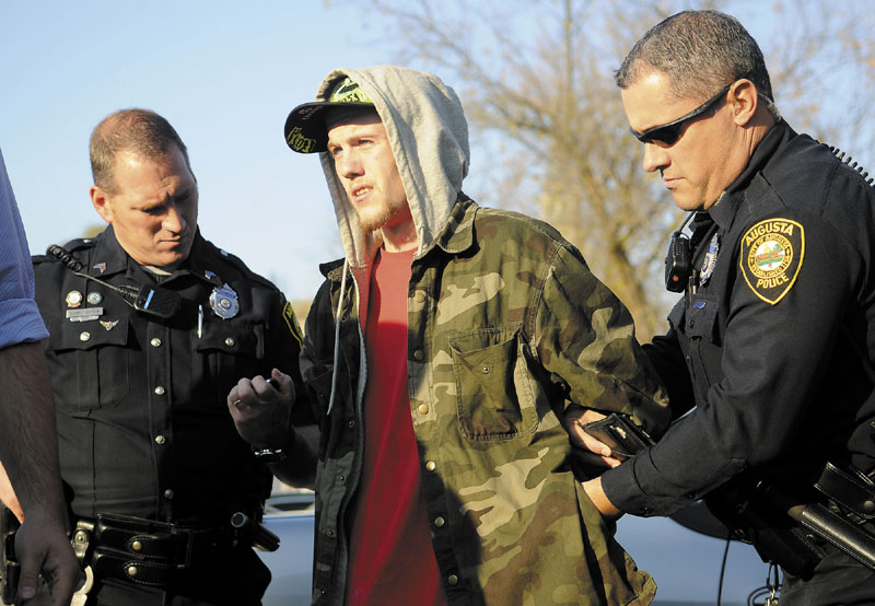 INDICTED: Augusta Police Dept. Sgt. Daniel Boivin, left, and Officer Chris Guay arrest Jake Pilsbury Oct. 31 in Augusta. Pilsbury was indicted Thursday on seven charges related to an alleged burglary.