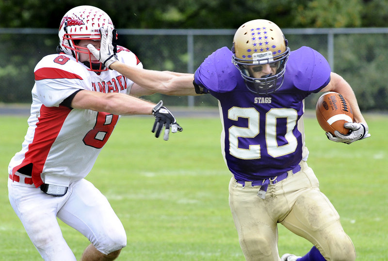 Spencer Cooke uses a stiff arm to evade a defender.