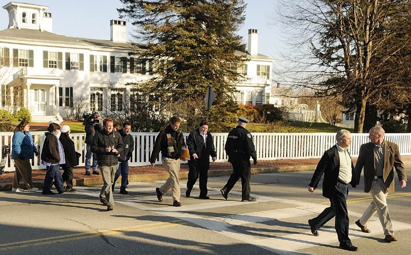 Four members of a group protesting outside the Blaine House are escorted by law enforcement officers and Governor's Office staff across the street to meet with Gov. Paul LePage on Saturday morning in Augusta. After walking over to his State House office they met for about an hour with him.