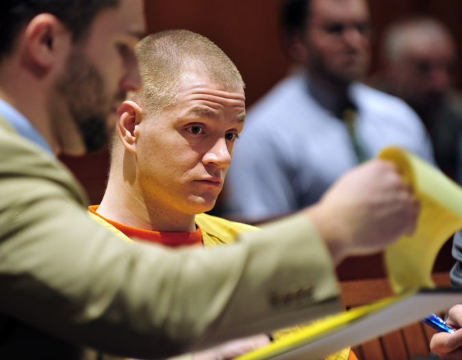 Shawn Garland stares at notes held by assistant attorney Peter Richard during his sentencing for murder in Superior Court today.