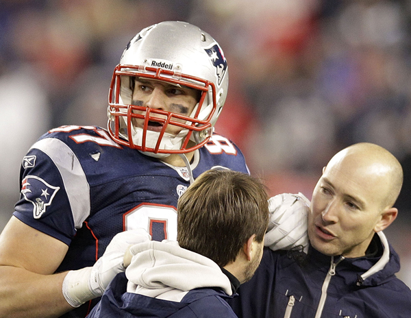 An injured Rob Gronkowski is helped off the field during the second half of the AFC Championship game against the Ravens on Sunday.