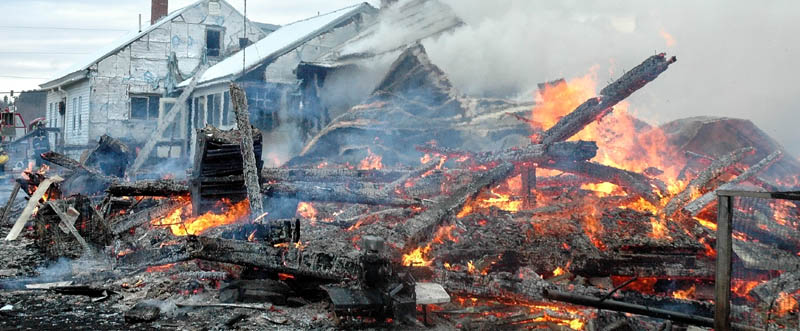 DESTROYED: The remnants of a large barn burn down Thursday after a fire destroyed it and part of an adjoining farm house at 49 Brighton Road, state Route 151. Firefighters from several towns battled the blaze. No one was injured and homeowner Angela Avery said the house were insured.