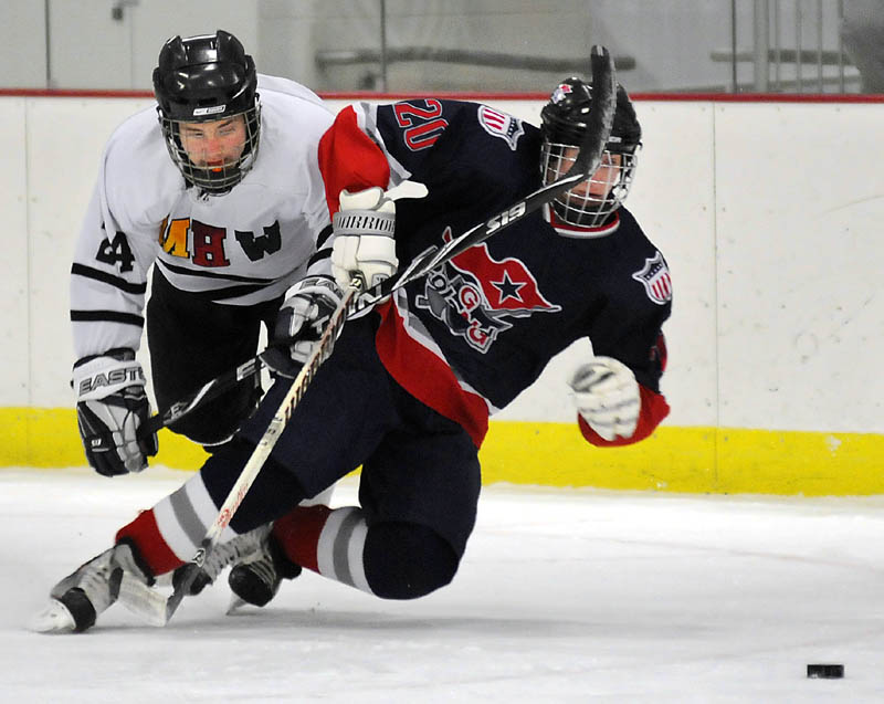 TRACKING THE PUCK: MHW’s Chris Stanley, left, and Gray-New Gloucester/Poland’s Evan Coulombe chase the puck during their game Monday in Readfield. MHW won 4-3.