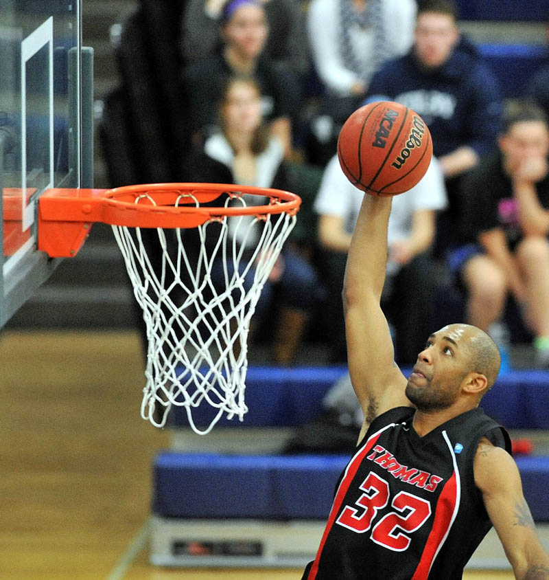 TO THE HOLE: Thomas College’s Martin Cleveland dunks the ball in the first half against Colby College earlier this season at Wadsworth Gymnasium at Colby College in Waterville.