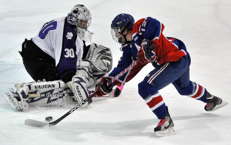 BIG NIGHT: Messalonskee's Chase Cunningham scores a goal on Waterville Senior High School's Cody Thibodeau in the first period Tuesday at Alfond Rink at Colby College in Waterville.