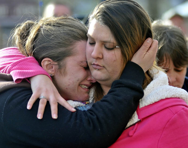 Staff photo by Michael G. Seamans Trista Reynolds, left, mother of Ayla Reynolds, is comforted by her friend Amanda Benner, during a vigil in Castonguay Square in Waterville for missing toddler, Ayla Reynolds Saturday.