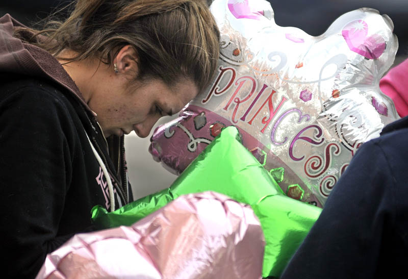 Staff photo by Michael G. Seamans Trista Reynolds takes a moment during a vigil in Castonguay Square in Waterville for her missing toddler, Ayla Reynolds Saturday.